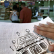 A patron at a Toronto McDonald’s holds the restaurant’s braille menu.